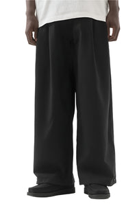 ASYMMETRICAL WOOL PLEATED PANTS